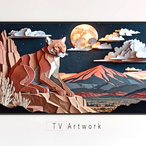 Puede incluir: Una ilustración de papel de una cordillera con luna llena y un puma marrón sentado en una roca. La obra de arte está enmarcada en un marco negro y tiene el texto "TV Artwork" debajo de la imagen.