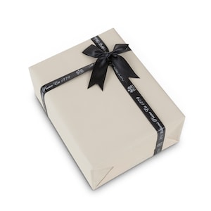 May include: A beige gift box with a black ribbon tied in a bow. The ribbon has the text "Fortnum & Mason Est 1779" printed on it.