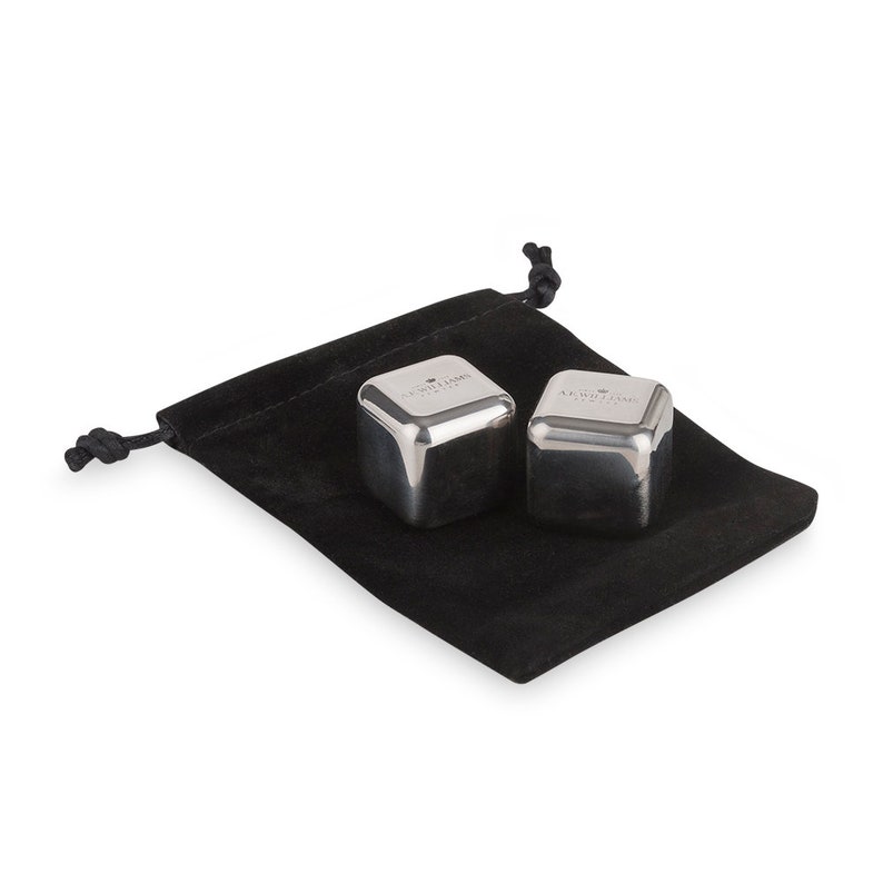 May include: Two silver metal ice cubes in a black velvet pouch. The ice cubes are engraved with the text "Chill with the King".