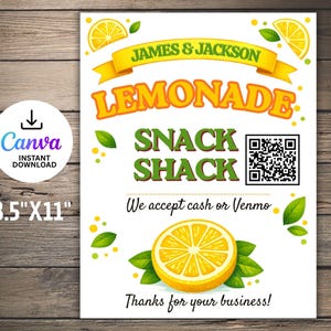 May include: A white sign with the text "JAMES & JACKSON LEMONADE SNACK SHACK". The sign includes a QR code, a lemon graphic, and the text "We accept cash or Venmo". The sign is 8.5" x 11".