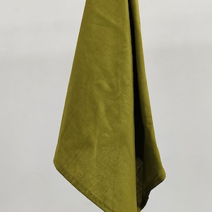 May include: A green linen kitchen towel hanging on a wooden rod.