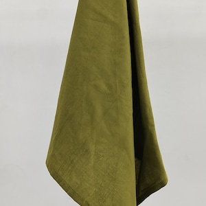 May include: A green linen kitchen towel hanging on a wooden rod.