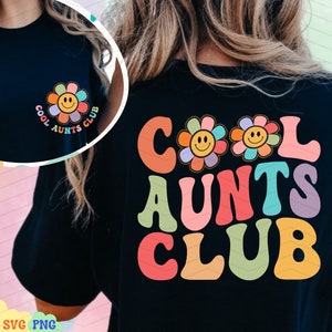 May include: Black t-shirt with a retro-style graphic that says "Cool Aunts Club" in rainbow colors. The graphic features three smiling flower faces.