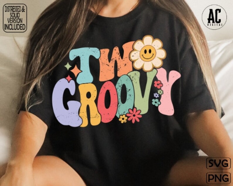 May include: A black t-shirt with a colorful retro design that says "Two Groovy" with a yellow flower with a smiley face in the center.