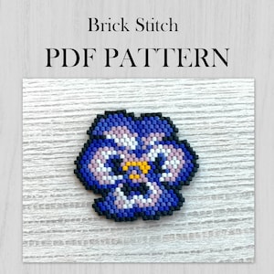 May include: A close-up of a purple, pink, white, and yellow beaded flower, created using the brick stitch technique. The flower is on a white wooden background. The text "Brick Stitch PDF PATTERN" is above the flower.