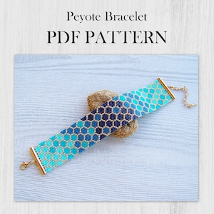 May include: A blue and gold peyote stitch bracelet with a geometric pattern. The bracelet is on a wooden surface and has a gold clasp.