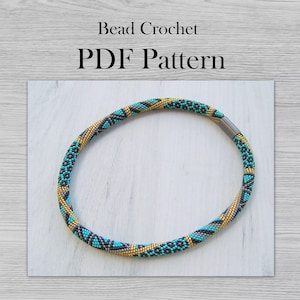 May include: A turquoise, black, and gold beaded necklace with a magnetic clasp. Bead Crochet PDF Pattern.