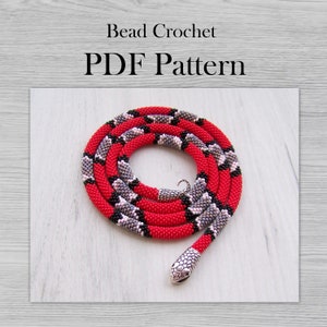 May include: A red, black and grey beaded snake necklace with a silver snake head charm. Bead crochet PDF pattern.