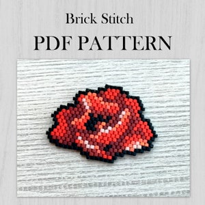May include: A red, orange, and black beaded flower pattern in brick stitch. The pattern is on a white wooden background. The text "Brick Stitch PDF PATTERN" is above the pattern.