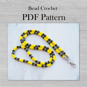May include: A yellow and black beaded lanyard with a silver clasp. Bead Crochet PDF Pattern.