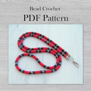 Peut inclure: Un cordon de perles rouge, noir et gris avec un fermoir argenté. Motif de crochet en perles PDF.