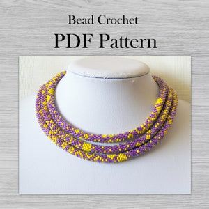 Könnte beinhalten: Eine Perlenkette mit einem Muster aus gelben und violetten Perlen. Die Kette befindet sich auf einem weißen Mannequin-Hals. Der Text "Bead Crochet PDF Pattern" befindet sich oben im Bild.
