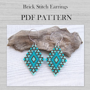 May include: Turquoise and brown beaded diamond-shaped earrings with silver hooks. The earrings are displayed on a piece of driftwood against a white wood background. The text "Brick Stitch Earrings PDF PATTERN" is at the top.