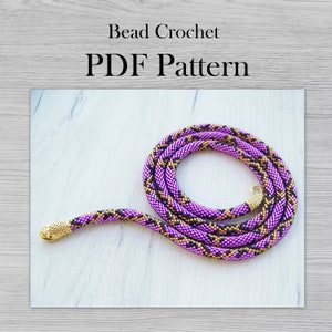 May include: A purple and black beaded snake necklace with a gold snake head charm. Bead Crochet PDF Pattern.