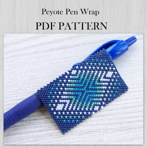 May include: A blue ballpoint pen featuring a peyote stitch beadwork wrap with a geometric pattern in shades of dark blue, light blue, and white. The text Peyote Pen Wrap PDF PATTERN is displayed above the pen on a light wood grain background.