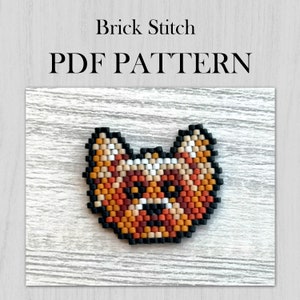 May include: A brick stitch pattern for a fox head, featuring orange, brown, black and white beads. The pattern is for a PDF download.