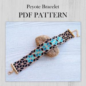 May include: A black and blue peyote stitch bracelet with a gold clasp. The bracelet is on a light wood surface.  PDF PATTERN.