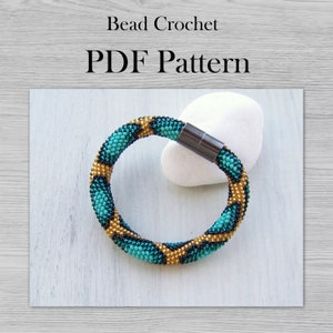 May include: A turquoise and gold beaded bracelet with a magnetic clasp. The bracelet is made with small beads and has a geometric pattern. Bead Crochet PDF Pattern.