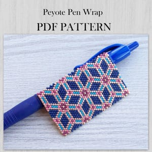 May include: A blue ballpoint pen featuring a peyote stitch beadwork wrap with a geometric pattern in dark blue, light blue, and metallic pink beads. The text Peyote Pen Wrap PDF PATTERN is displayed above the pen on a light wood grain background.