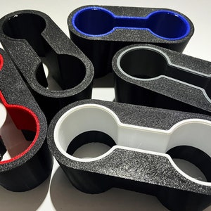 May include: Five black foam cup holders with different colored inner rims. The rims are red, white, blue, and gray.