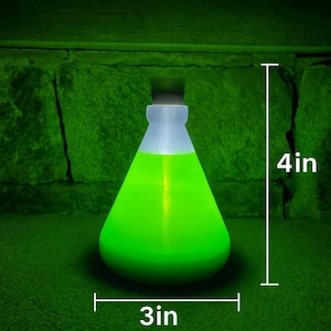 May include: A glowing green potion bottle, 4 inches tall and 3 inches wide, with a black stopper and a white neck. The bottle is filled with a bright green liquid, creating a magical or fantasy aesthetic.