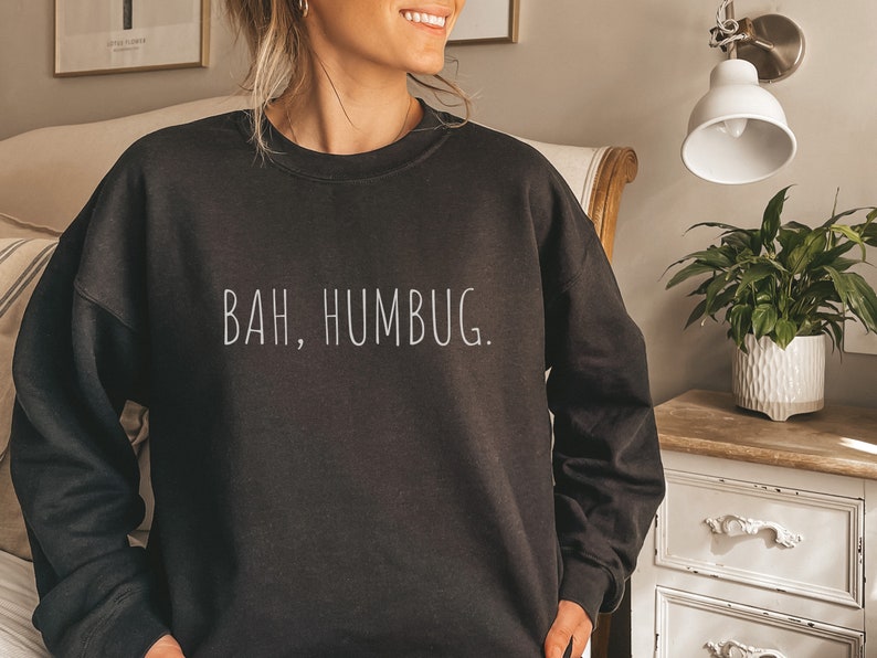 May include: Black sweatshirt with the text "BAH, HUMBUG." printed in white on the front.