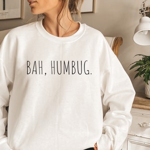 May include: White sweatshirt with the text "BAH, HUMBUG." printed in black.