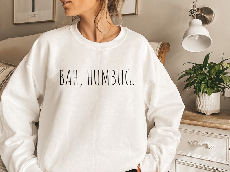 May include: White sweatshirt with the text "BAH, HUMBUG." printed in black.