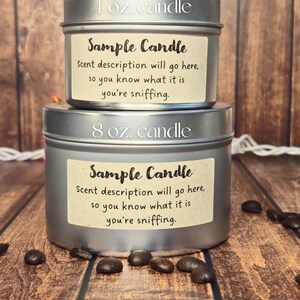 May include: Two silver candle tins with labels that say "Sample Candle" and include the text "Scent description will go here, so you know what it is you're sniffing." The smaller tin is labeled "4 oz. candle" and the larger tin is labeled "8 oz. candle".