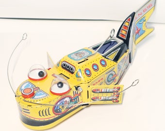 Space Whale Yellow.Vintage Wind Up Tin Toy Retro Collectible Yellow Whale.Design and production by Saint John