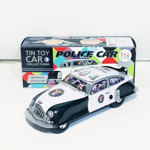 パトカー。ビンテージのゼンマイ式ブリキおもちゃのレトロ