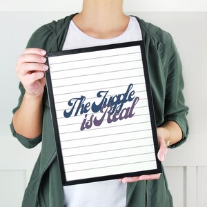 May include: A black framed print with white lined paper and the text "The Juggle is Real" in a blue and purple gradient font.