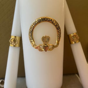 Elegant and very special 3 piece Claddagh Unity Candle Set which symbolizes Friendship, Loyalty and Love. Pillar candle is 8 inches tall.