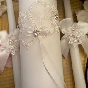 Beautiful 3 piece Heart Unity Candle Set. Interlocking hearts and rhinestones make this set extra special! Candle is 8 inches tall.