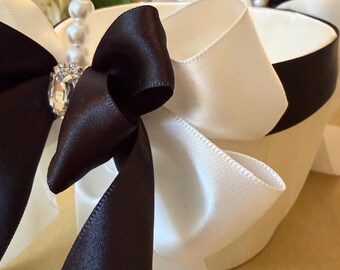Elegant black and white flower girl basket has it all with silky black and white ribbons, pearl handle and rhinestones! A true show stopper!