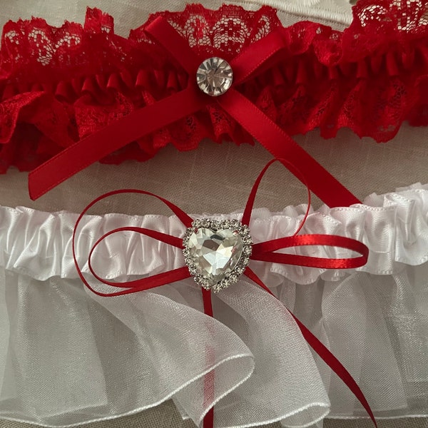 Simply elegant 2 piece garter set! Lovely set comes with keepsake garter with heart rhinestone and red toss garter. Boxed for gift giving.