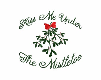May include: An embroidery design featuring a sprig of green mistletoe with white berries and a red bow, centered between the dark green cursive text that reads Kiss Me Under The Mistletoe, arranged in a circular pattern on a plain white background.