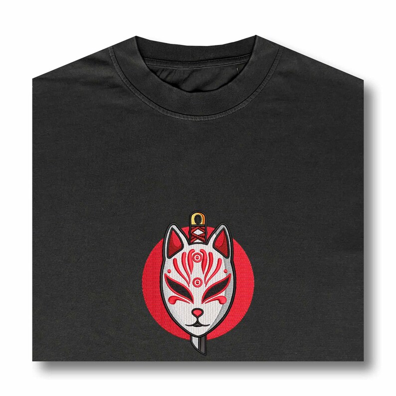 May include: Black t-shirt with a red circle and a white fox mask with a sword through it.