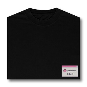 May include: Black t-shirt with a pink and white system error pop-up graphic. The graphic says "System error" and has an "OK" button.