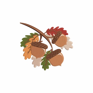 May include: An embroidery design featuring three brown acorns with textured caps attached to a curved brown branch, surrounded by several oak leaves in shades of red, orange, light beige, and green, rendered with visible stitch patterns.