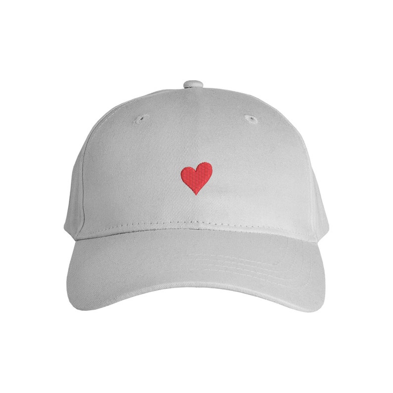 May include: A gray baseball cap with a red heart embroidered on the front.