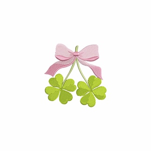 May include: Two green four-leaf clovers with a pink bow tied at the top of the stems.