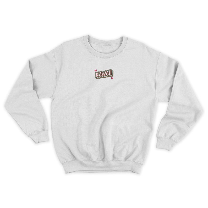 May include: White sweatshirt with a pink and brown "KAWAII" graphic with two pink hearts above and below the text.