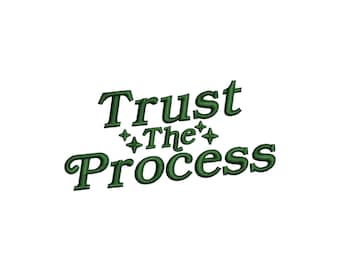 May include: An embroidery design featuring the dark green text Trust The Process arranged in three lines with four small four-pointed star icons interspersed between the words, all set against a plain white background.