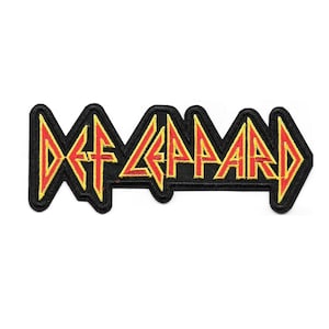 May include: Black and yellow embroidered patch with the word "DEF LEPPARD" in a stylized font.