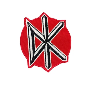 May include: Red and white embroidered patch with a stylized "DK" logo. The patch is circular with a jagged edge.