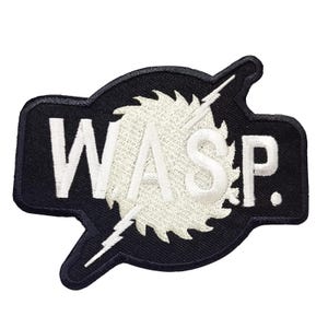 May include: Black and white embroidered patch featuring the word "WASP" and a circular saw blade design.
