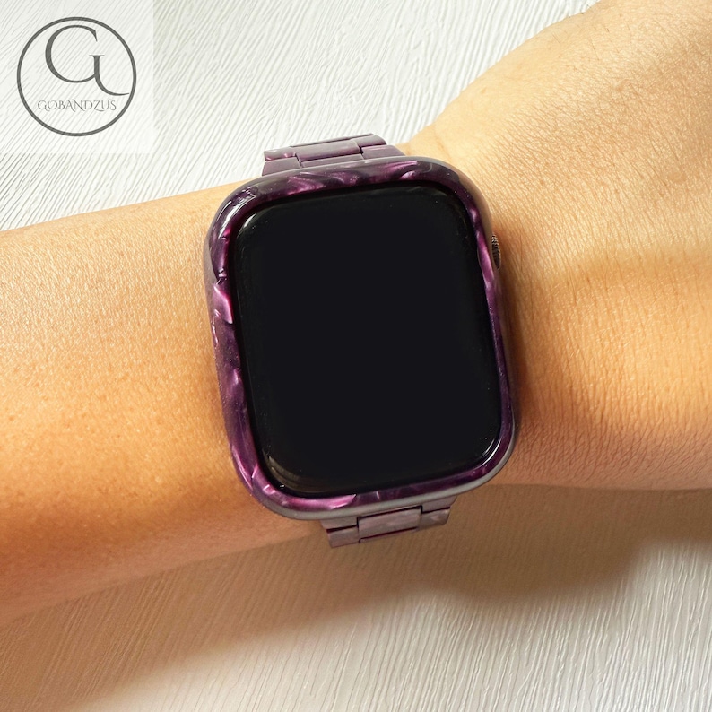 May include: A smartwatch featuring a dark purple and black marbled resin case and matching link band. The watch face is black and rectangular with rounded corners. The design displays a glossy, swirling pattern throughout the frame and strap.
