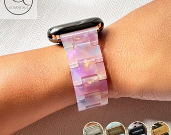 May include: A watch band featuring translucent, iridescent pink and purple resin links with a glossy finish. The band connects to a black watch casing. Four small circular thumbnails at the bottom display metal clasps in silver, gold, black, and rose gold finishes with the text Custom Engrave Available.