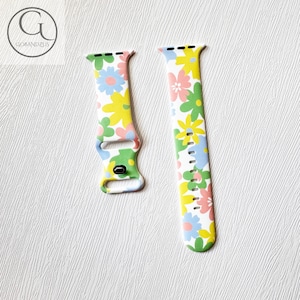 May include: White Apple Watch band with a floral pattern in shades of pink, yellow, blue, and green.